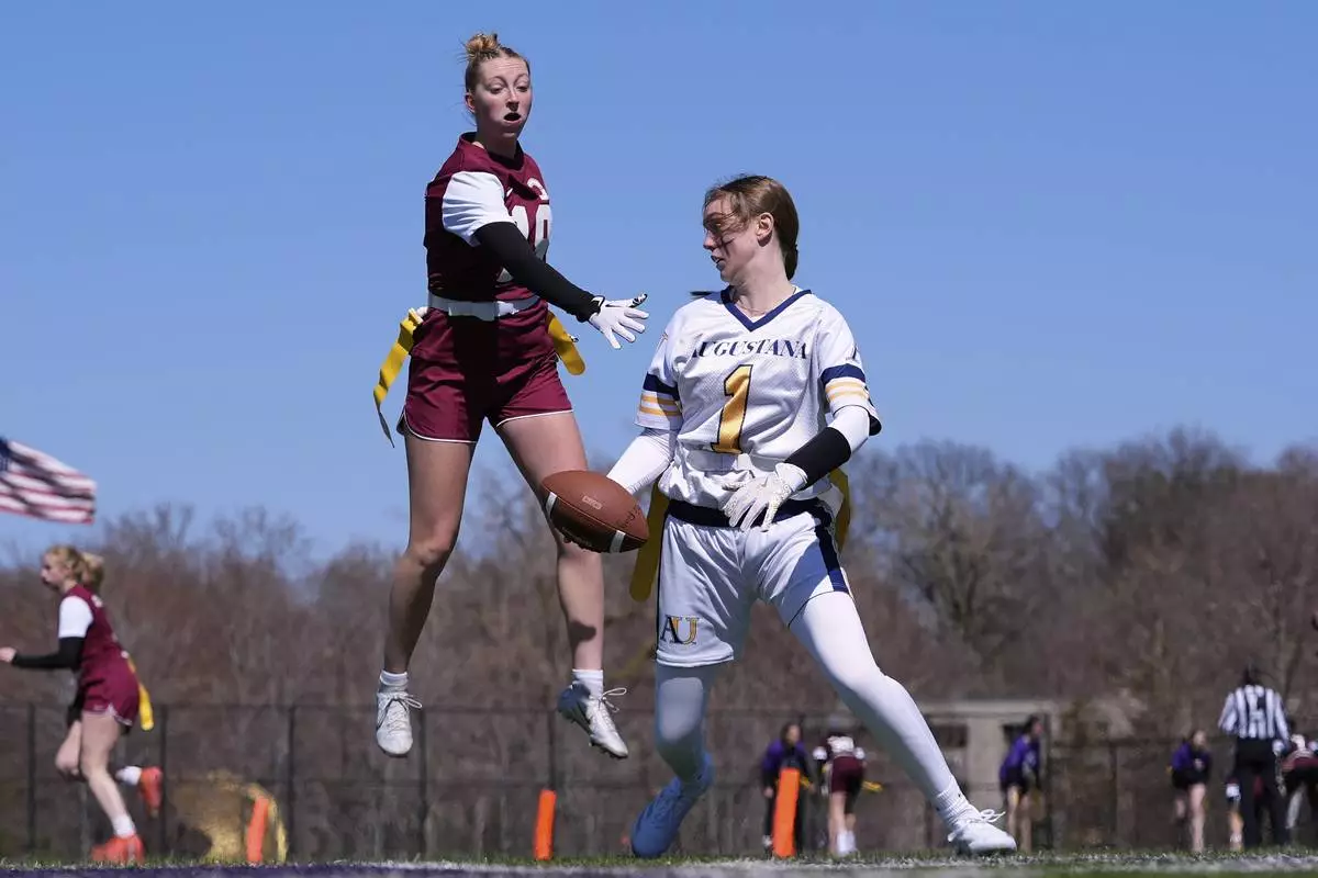 Augustana University and Concordia University, St. Paul players compete during a women's college flag football game, April 7, 2025, in St. Paul. Minn. (AP Photo/Abbie Parr)