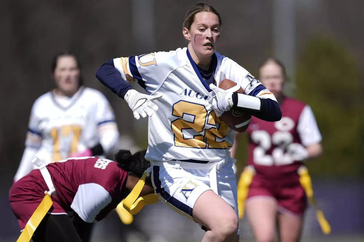 Augustana University and Concordia University, St. Paul players compete during a women's college flag football game, April 7, 2025, in St. Paul. Minn. (AP Photo/Abbie Parr)