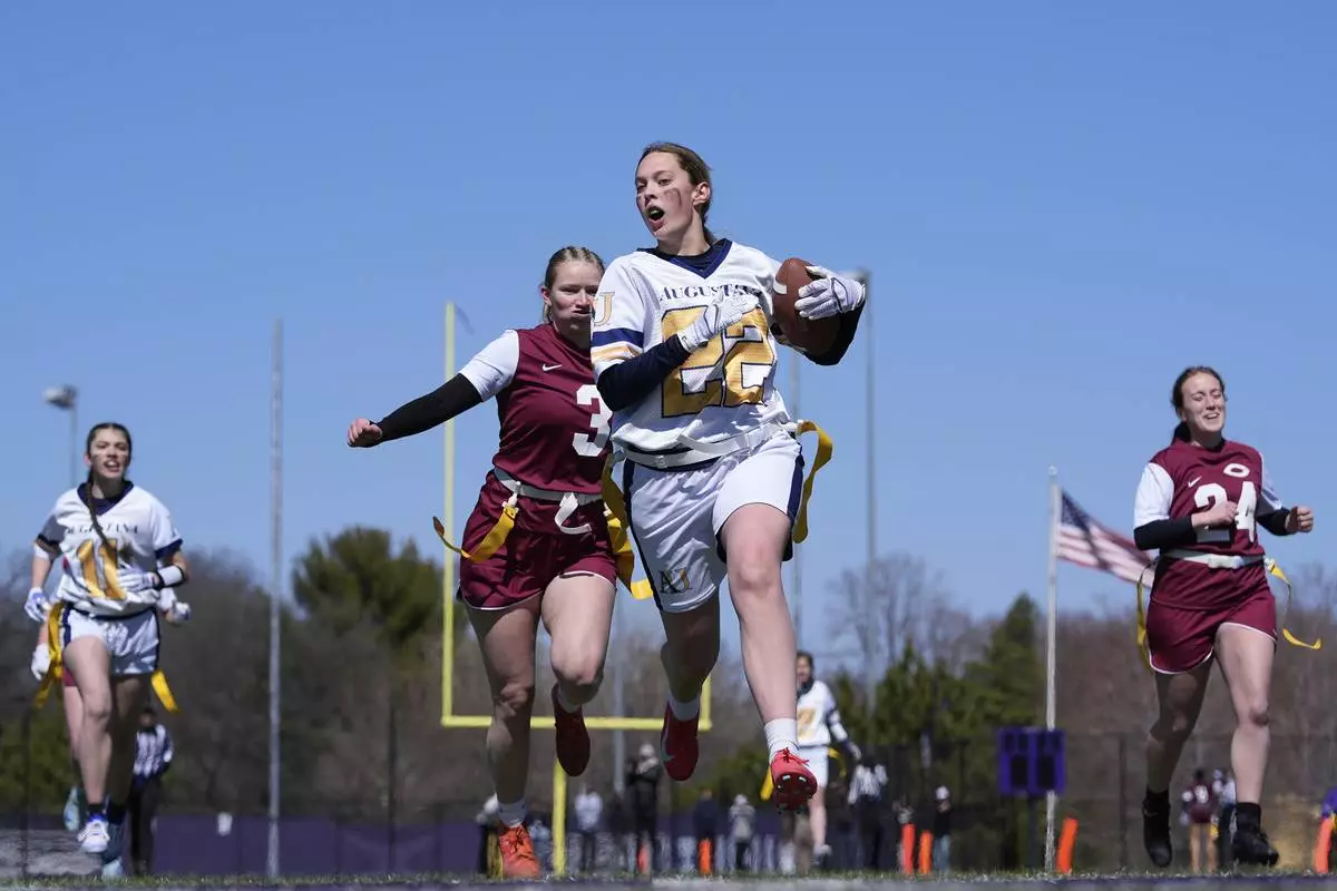 Augustana University and Concordia University, St. Paul players compete during a women's college flag football game, April 7, 2025, in St. Paul. Minn. (AP Photo/Abbie Parr)