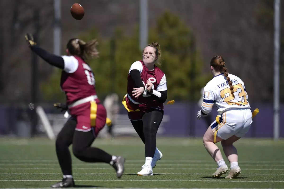 Augustana University and Concordia University, St. Paul players compete during a women's college flag football game, April 7, 2025, in St. Paul. Minn. (AP Photo/Abbie Parr)