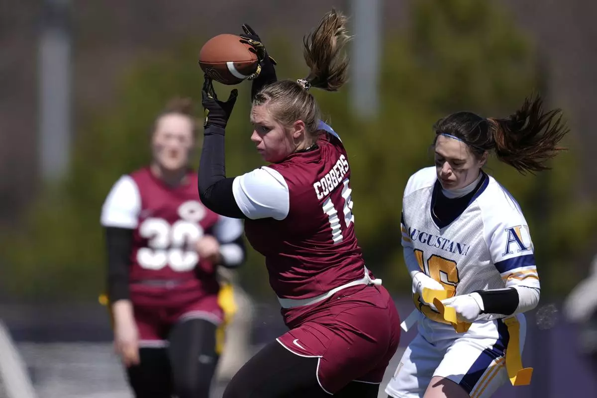 Augustana University and Concordia University, St. Paul players compete during a women's college flag football game, April 7, 2025, in St. Paul. Minn. (AP Photo/Abbie Parr)