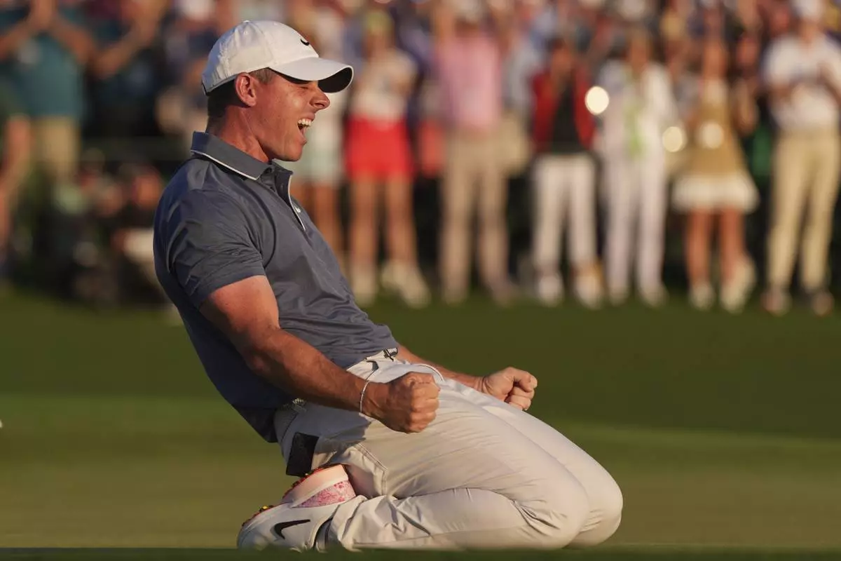 Rory McIlroy, of Northern Ireland, celebrates winning in a playoff against Justin Rose, of England, after the final round the Masters golf tournament, Sunday, April 13, 2025, in Augusta, Ga. (AP Photo/Matt Slocum)