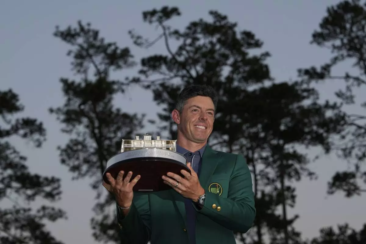 Winner Rory McIlroy, of Northern Ireland, holds the trophy at the Masters golf tournament, Sunday, April 13, 2025, in Augusta, Ga. (AP Photo/David J. Phillip)