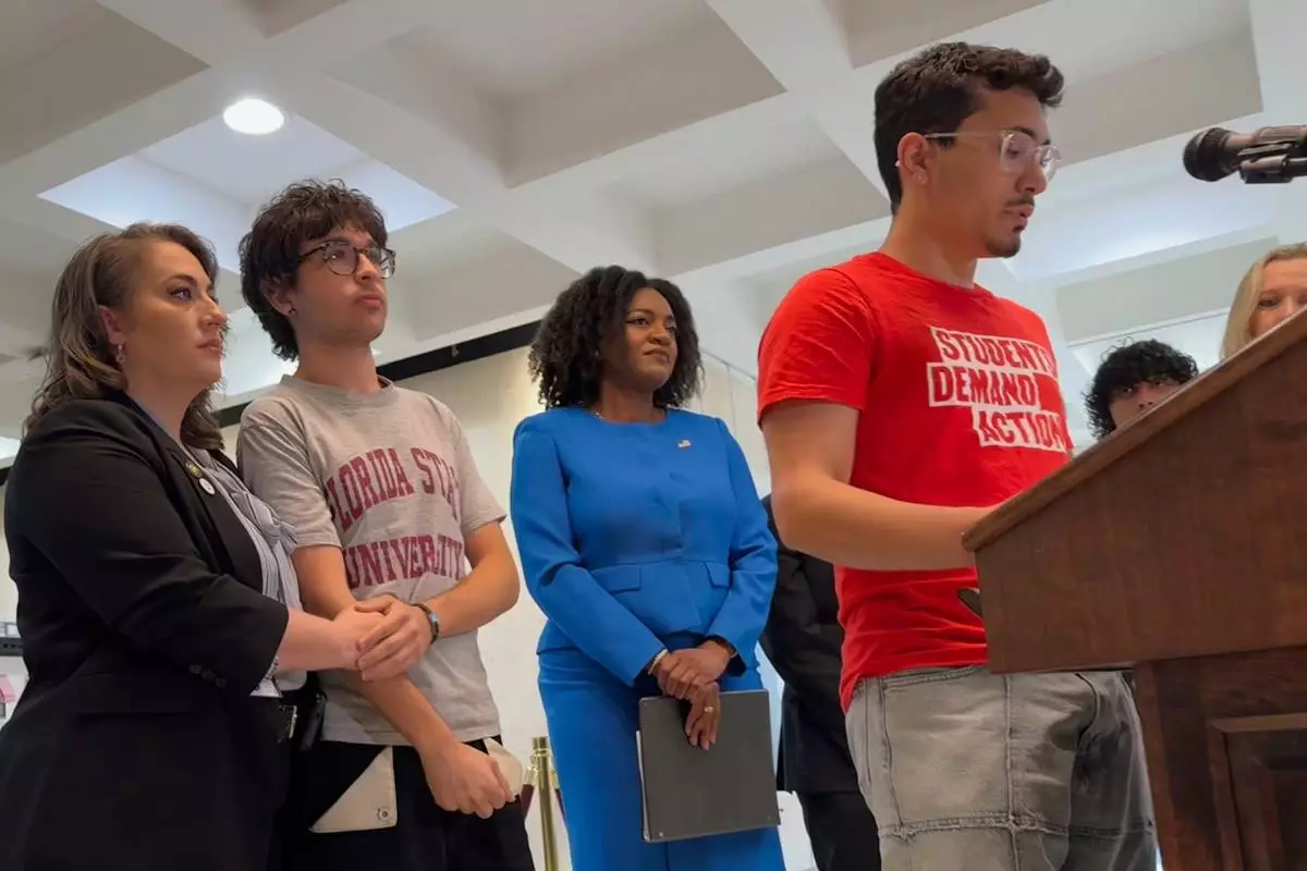 Andres Perez, a 20-year-old junior at Florida State University, speaks at a nes conference in the state capitol in Tallahassee, Fla. alongside Democratic lawmakers on Tuesday, April 22, 2025. (AP Photo/Kate Payne)