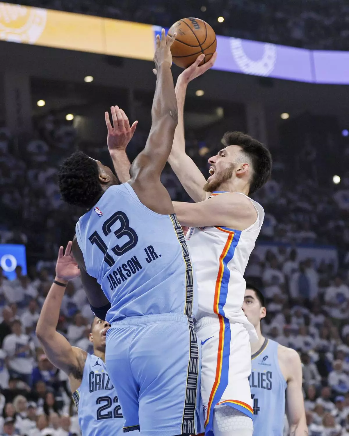 Oklahoma City Thunder forward Chet Holmgren (7) looks to shoot over Memphis Grizzlies forward Jaren Jackson Jr. (13) during the first half in Game 1 of an NBA first-round playoff series, Sunday, April 20, 2025, in Oklahoma City. (AP Photo/Nate Billings)