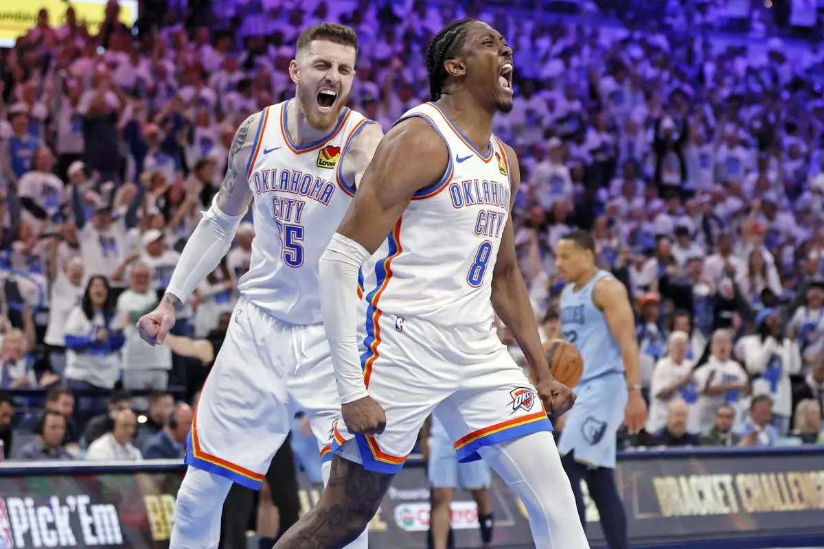 Oklahoma City Thunder center Isaiah Hartenstein, left, and forward Jalen Williams (8) react after a dunk by Williams during the first half in Game 1 of an NBA first-round playoff series against the Memphis Grizzles, Sunday, April 20, 2025, in Oklahoma City. (AP Photo/Nate Billings)
