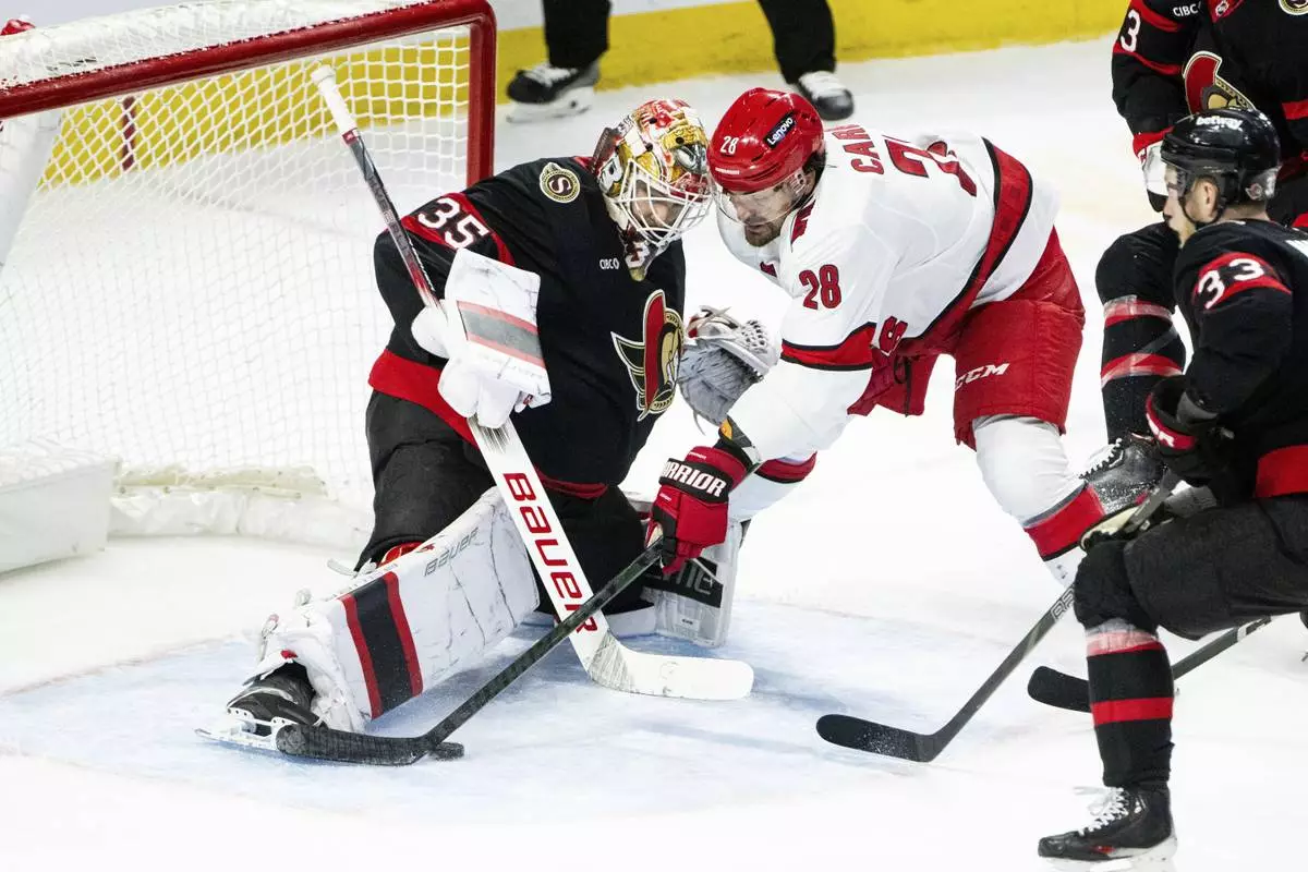 Carolina Hurricanes left wing William Carrier (28) tries to score against Ottawa Senators goaltender Linus Ullmark (35) during third-period NHL hockey game action in Ottawa, Ontario, Thursday, April 17, 2025. (Spencer Colby/The Canadian Press via AP)