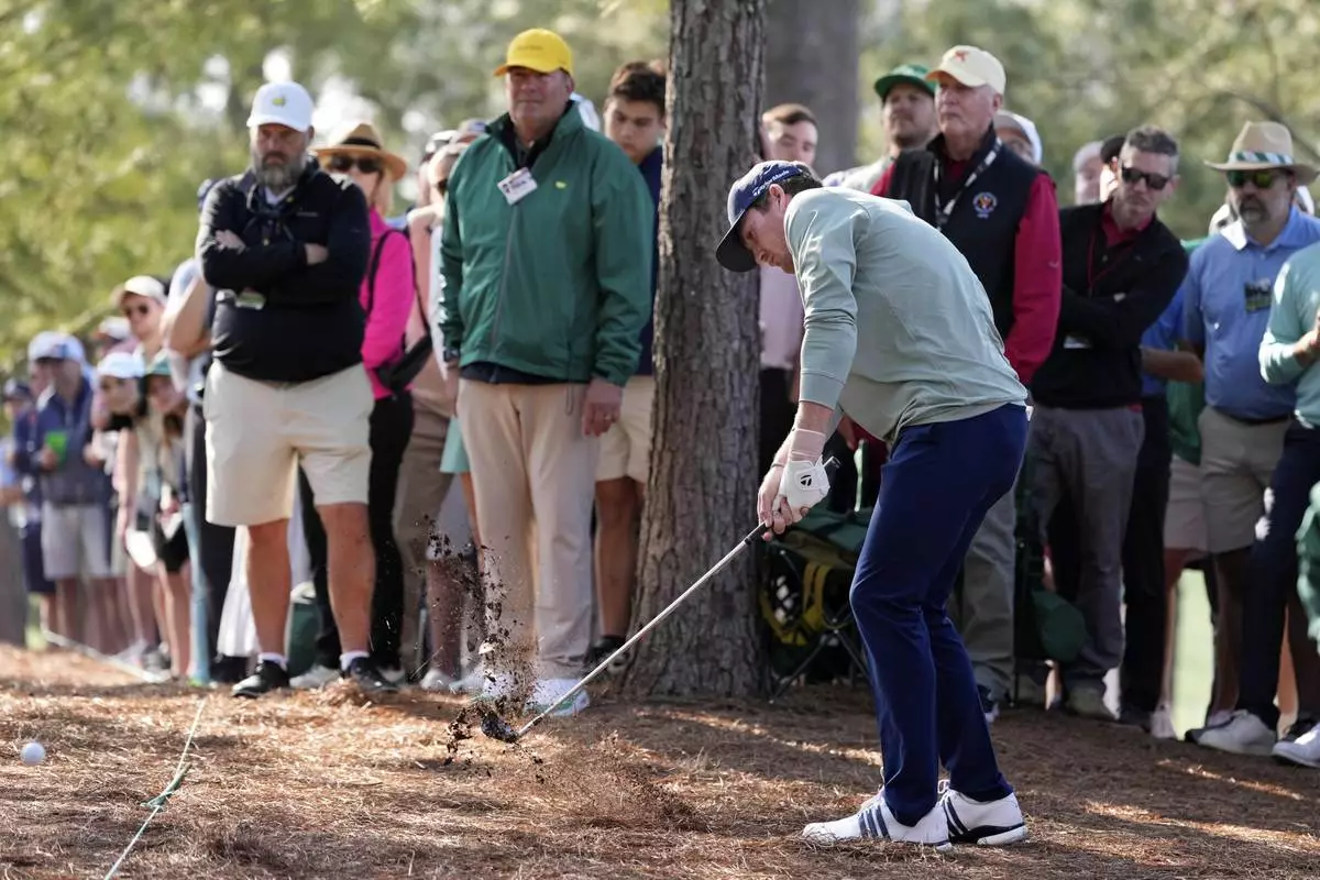 Nick Dunlap hits from the pine straw on the first hole during the first round at the Masters golf tournament, Thursday, April 10, 2025, in Augusta, Ga. (AP Photo/Ashley Landis)