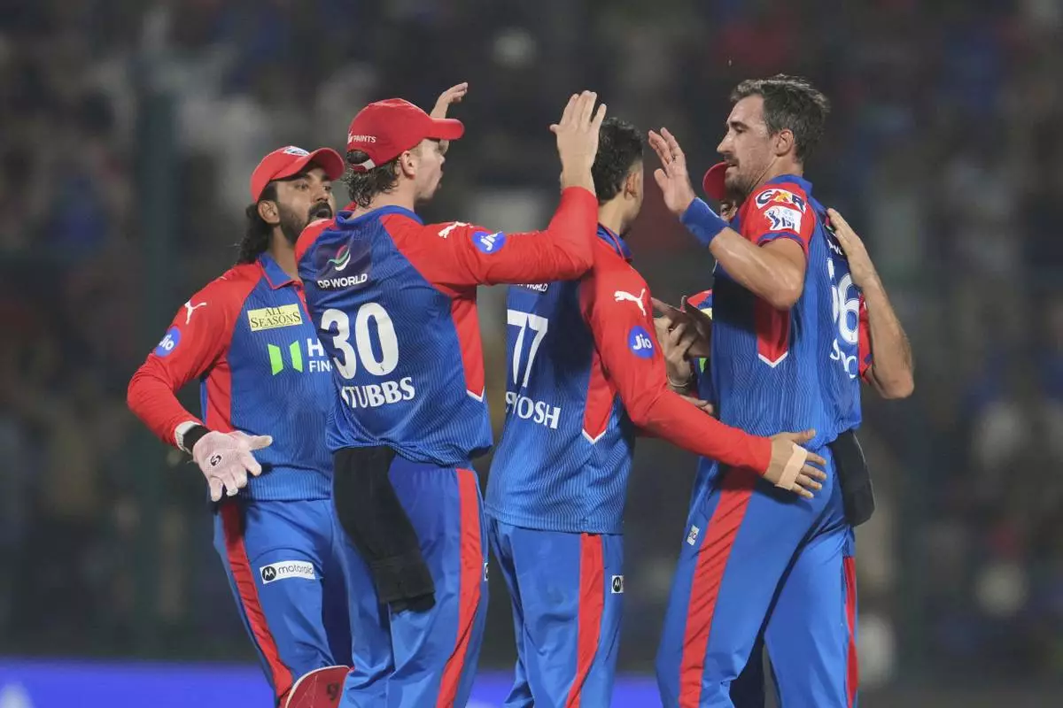 Delhi Capitals' Mitchell Starc, right, celebrates with teammates after the dismissal of Rajasthan Royals' Dhruv Jurel during the Indian Premier League cricket match between Delhi Capitals and Rajasthan Royals at Arun Jaitley Stadium in New Delhi, India, Wednesday, April 16, 2025. (AP Photo/Manish Swarup)