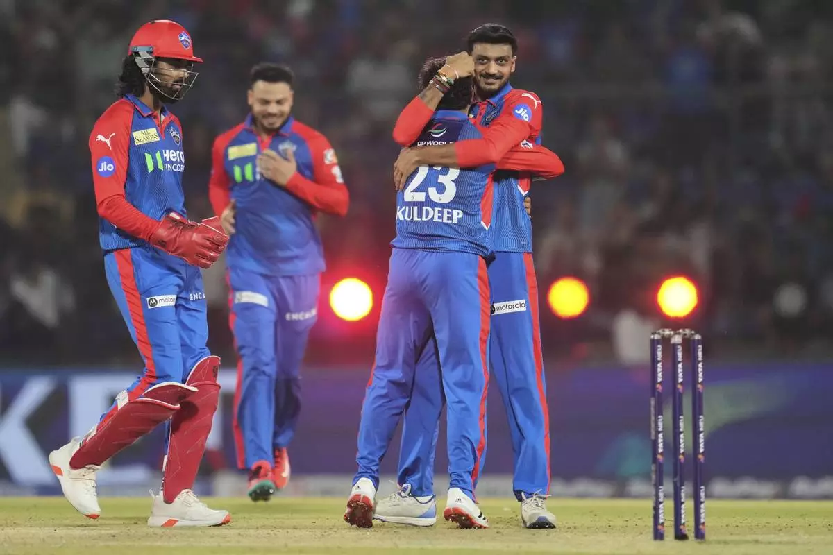 Delhi Capitals' Kuldeep Yadav (23) is congratulated by captain Axar Patel after taking the wicket of Rajasthan Royals' Yashasvi Jaiswal during the Indian Premier League cricket match between Delhi Capitals and Rajasthan Royals at Arun Jaitley Stadium in New Delhi, India, Wednesday, April 16, 2025. (AP Photo/Manish Swarup)