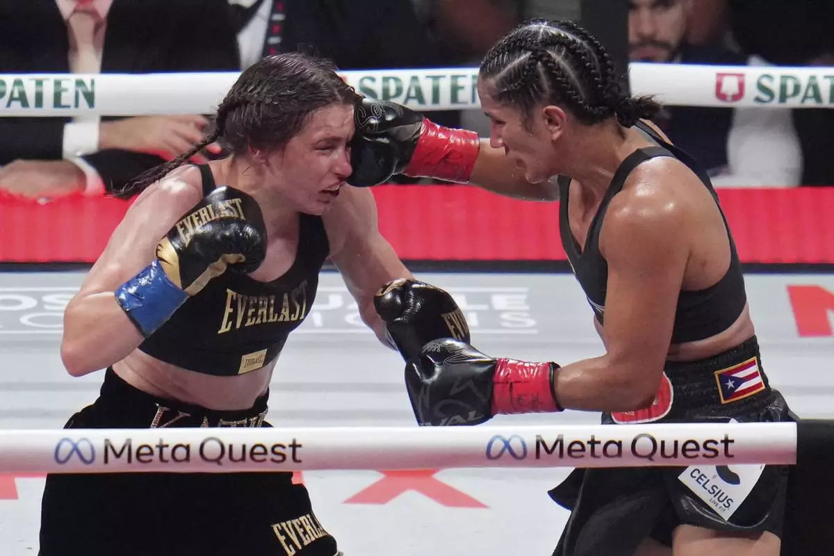 FILE - Amanda Serrano hits Katie Taylor during their undisputed super lightweight title bout, Friday, Nov. 15, 2024, in Arlington, Texas. (AP Photo/Julio Cortez, File)