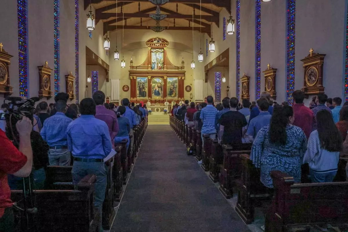 A service is held at Co-Cathedral of St. Thomas More, a Catholic cathedral, across from the Woodward Avenue entrance to Florida State University campus, following a shooting, Thursday, April 17, 2025, in Tallahassee, Fla. (AP Photo/Gary McCullough)