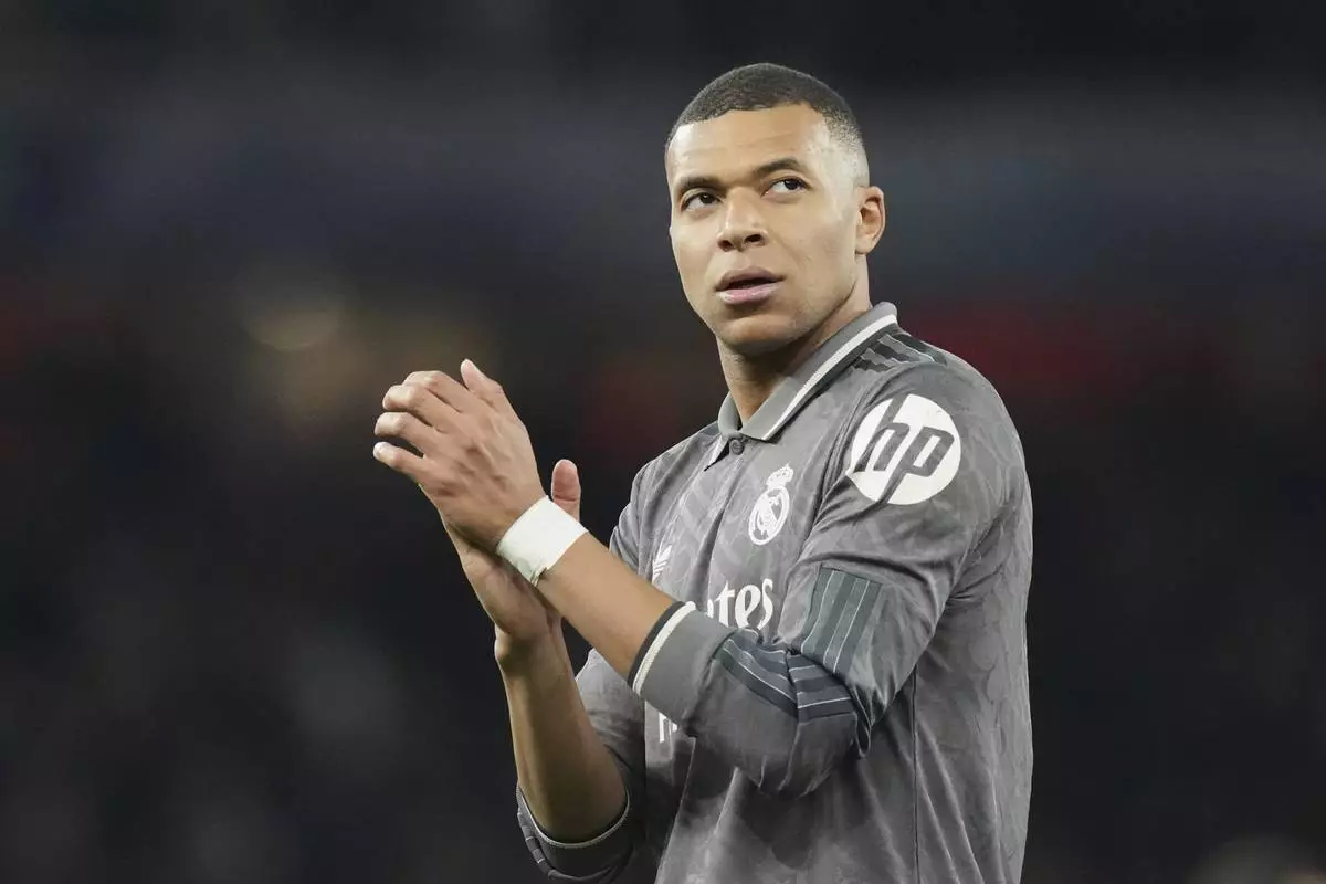 Real Madrid's Kylian Mbappe applauds fans at the end of the Champions League quarterfinal first leg soccer match between Arsenal and Real Madrid at the Emirates Stadium in London, Tuesday, April 8, 2025. (AP Photo/Frank Augstein)