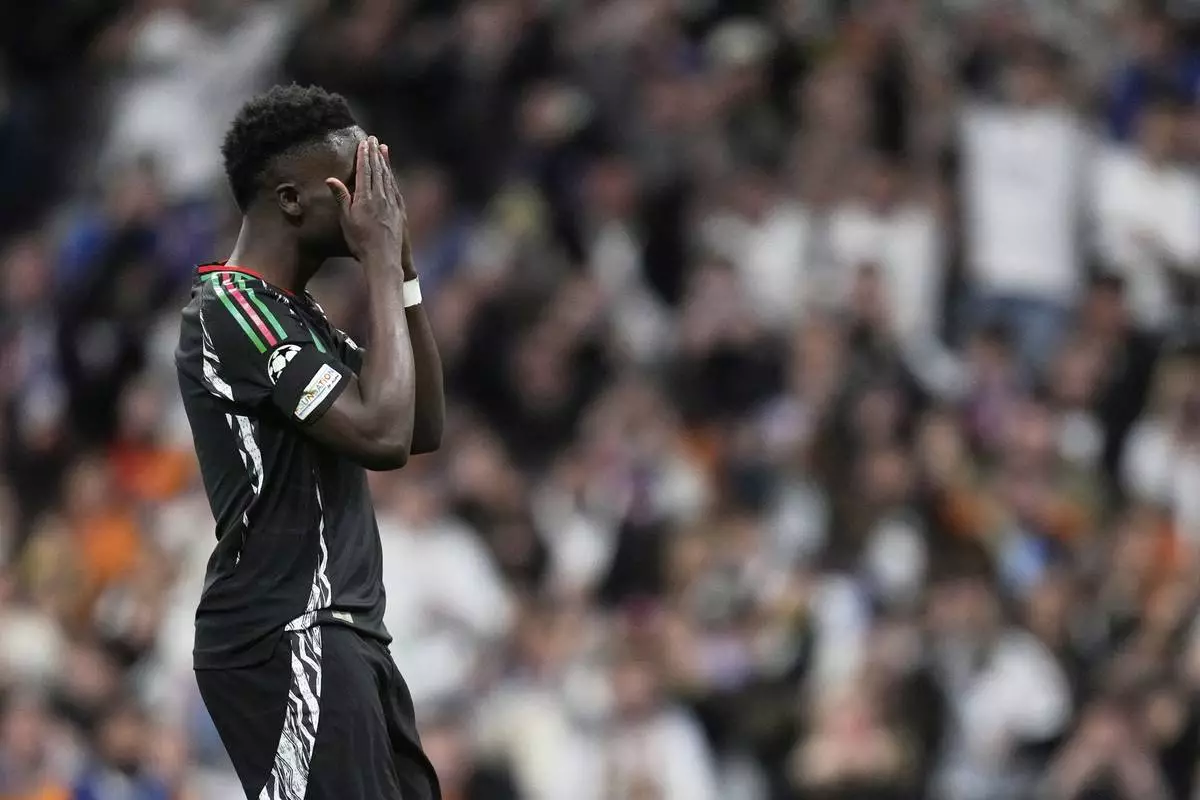 Arsenal's Bukayo Saka reacts after missing a chance to score during the Champions League quarterfinals second leg soccer match between Real Madrid and Arsenal at the Santiago Bernabeu stadium in Madrid, Wednesday, April 16, 2025. (AP Photo/Bernat Armangue)