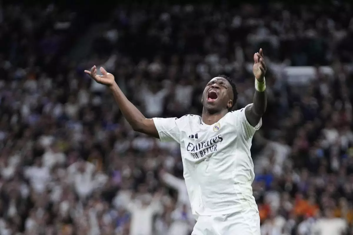 Real Madrid's Vinicius Junior reacts during the Champions League quarterfinals second leg soccer match between Real Madrid and Arsenal at the Santiago Bernabeu stadium in Madrid, Wednesday, April 16, 2025. (AP Photo/Bernat Armangue)