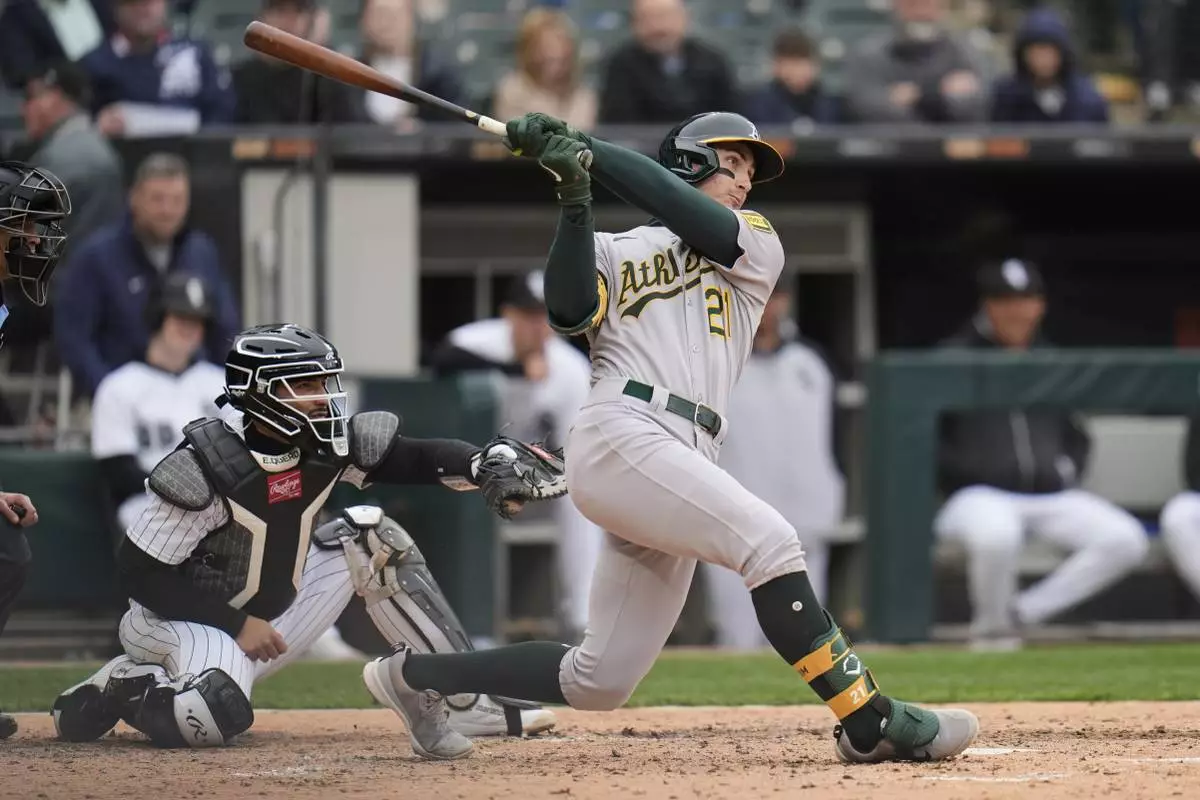 Athletics' Tyler Soderstrom, right, hits a home run during the seventh inning of a baseball game against the Chicago White Sox, Thursday, April 17, 2025, in Chicago. (AP Photo/Erin Hooley)