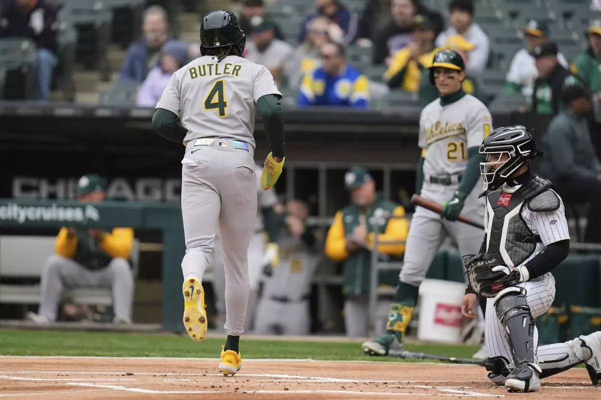 Athletics' Lawrence Butler (4) scores on a double from Jacob Wilson during the first inning of a baseball game against the Chicago White Sox, Thursday, April 17, 2025, in Chicago. (AP Photo/Erin Hooley)