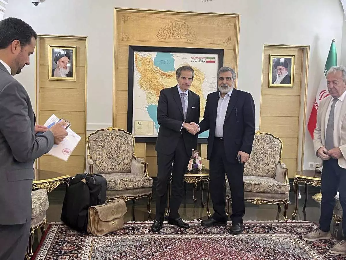 In this photo released by the Atomic Energy Organisation of Iran, International Atomic Energy Agency (IAEA) Director General, Rafael Mariano Grossi, left, shakes hands with deputy chief of Atomic Energy Organisation of Iran, Behrouz Kamalvandi, upon his arrival at Mehrabad airport in Tehran, Iran, Wednesday, April 16, 2025. (Atomic Energy Organisation of Iran via AP)