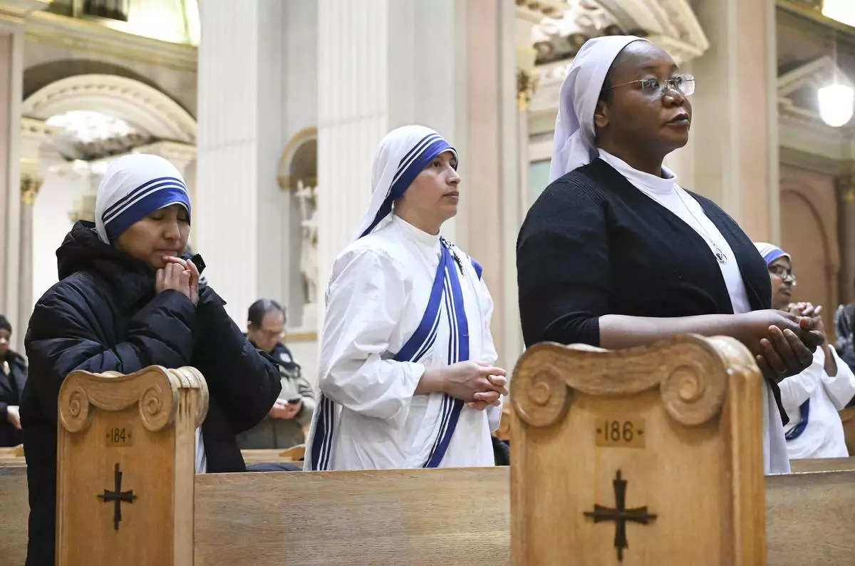 Church goers attend a mass to commemorate the late Pope Francis in Montreal, Saturday, April 26, 2025. (Graham Hughes /The Canadian Press via AP)