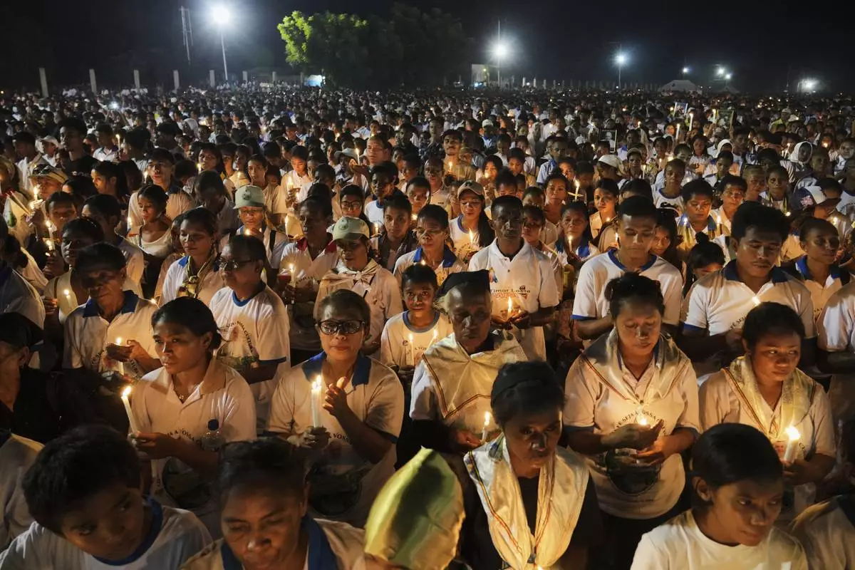 Devotees light candles during a Requiem Mass for the late Pope Francis, in Dili, East Timor, Saturday, April 26, 2025. (AP Photo/Firdia Lisnawati)