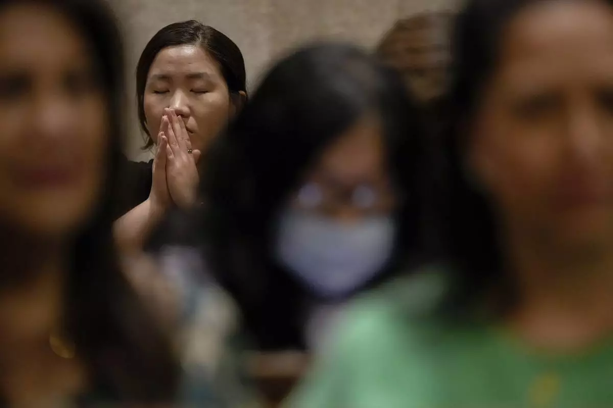 A parishioner prays during a memorial mass for the late Pope Francis at St. Patrick's Cathedral, Saturday, April 26, 2025, in New York. (AP Photo/Julia Demaree Nikhinson)