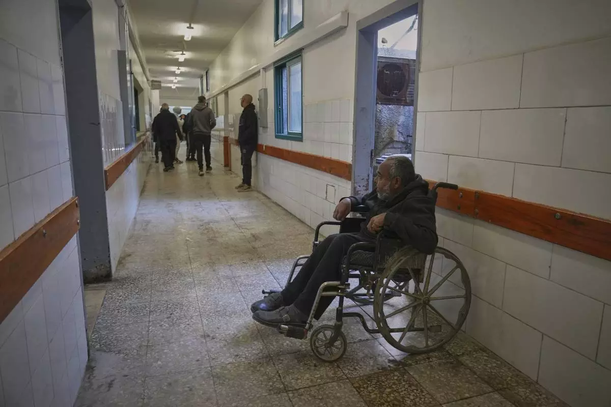 Mohamed Attiya, 54, waits for a dialysis session in a corridor at Shifa hospital in Gaza City, Monday, April 14, 2025.(AP Photo/(AP Photo/Jehad Alshrafi)
