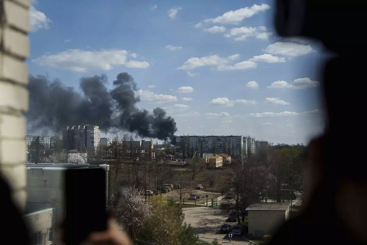 Smoke rises from an explosion following a Russian drone strike on Sumy, Ukraine, Monday, April 14, 2025. (AP Photo/Evgeniy Maloletka)