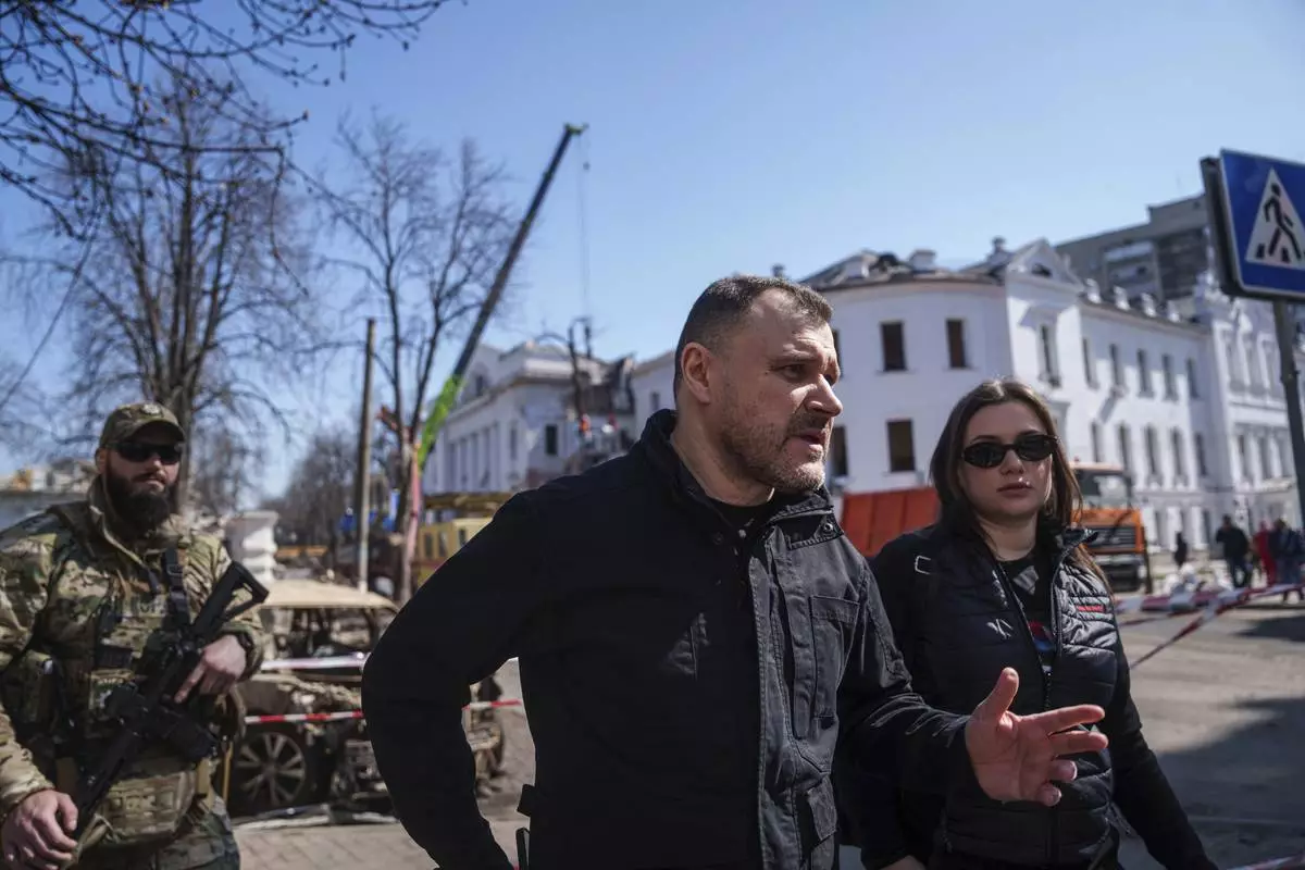 Ukrainian Interior Minister Ihor Klymenko visits the site of the Russian missile attack in Sumy, Ukraine, Monday, April 14, 2025. (AP Photo/Evgeniy Maloletka)