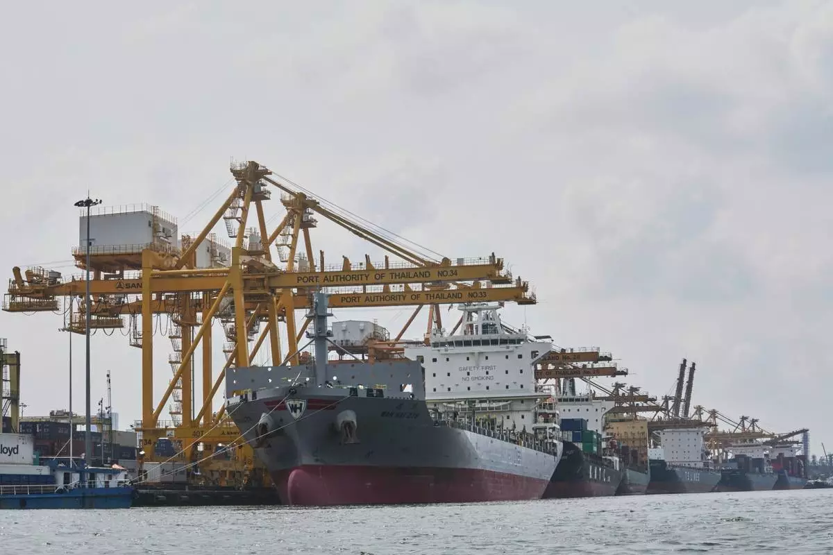 Cranes work on stacks of containers at Bangkok Port in Bangkok, Thailand, Wednesday, April 9, 2025. (AP Photo/Sakchai Lalit)