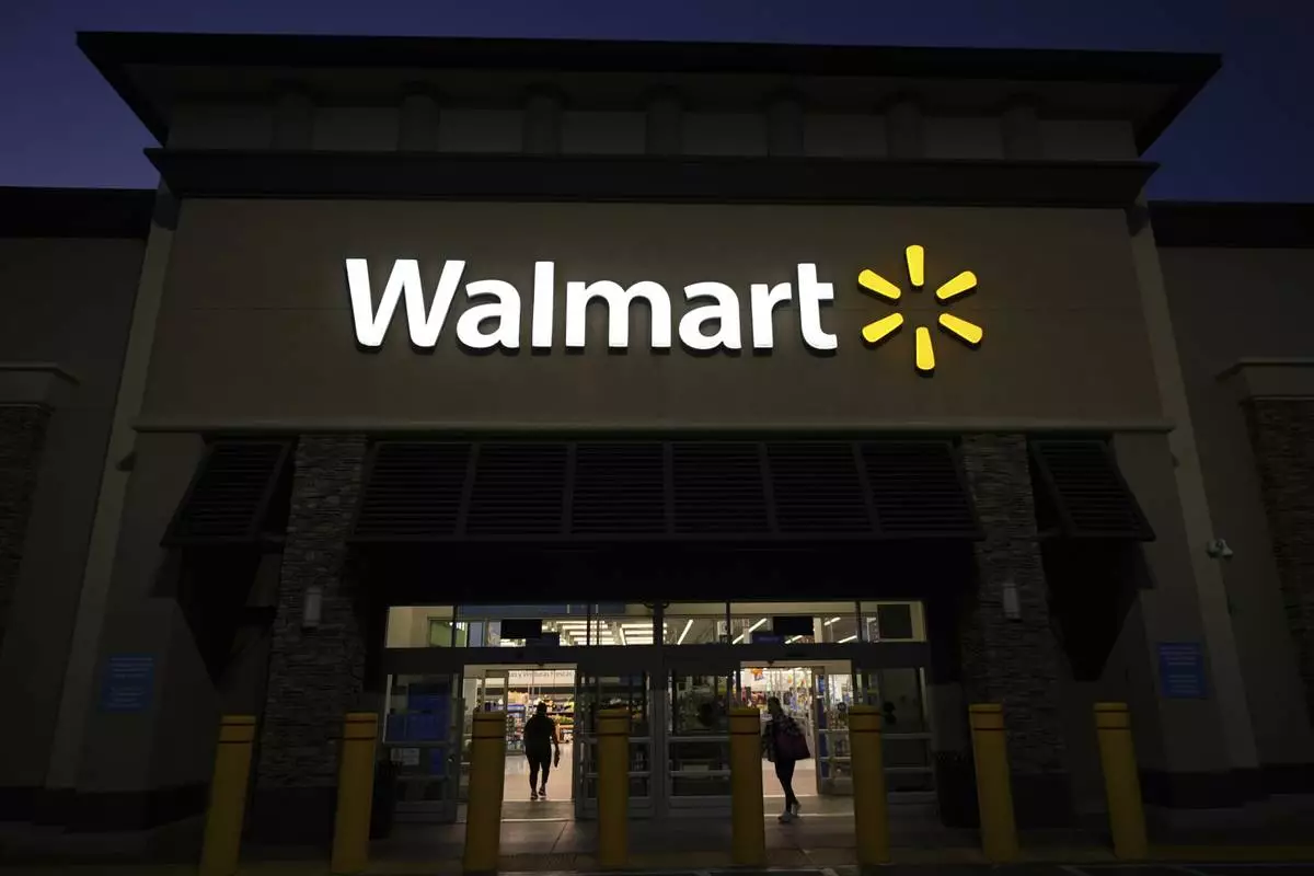 Shoppers enter a Walmart store in La Habra, Calif., Wednesday, April 9, 2025. (AP Photo/Jae C. Hong)