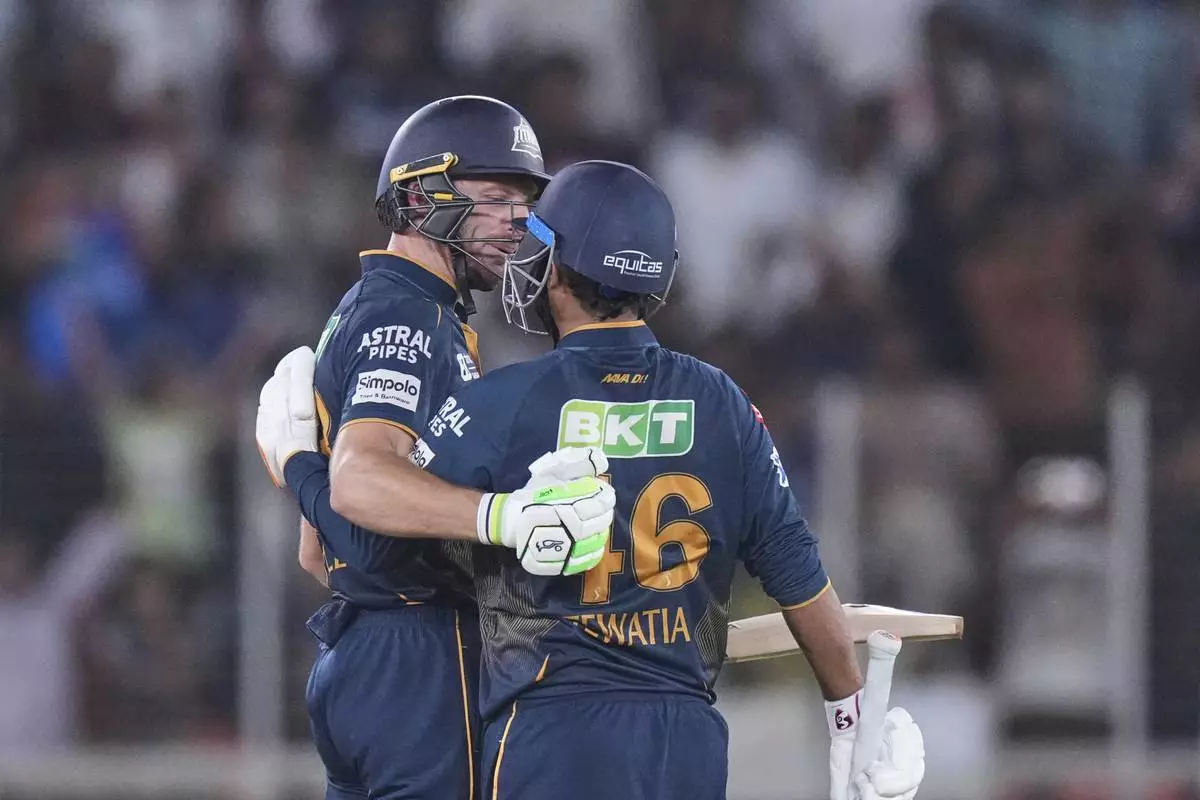 Gujarat Titans' Rahul Tewatia with batting partner Jos Butler celebrates after wining against Delhi Capitals during the Indian Premier League cricket match at Narendra Modi Stadium in Ahmedabad, India, Saturday, April 19, 2025. (AP Photo/Ajit Solanki)
