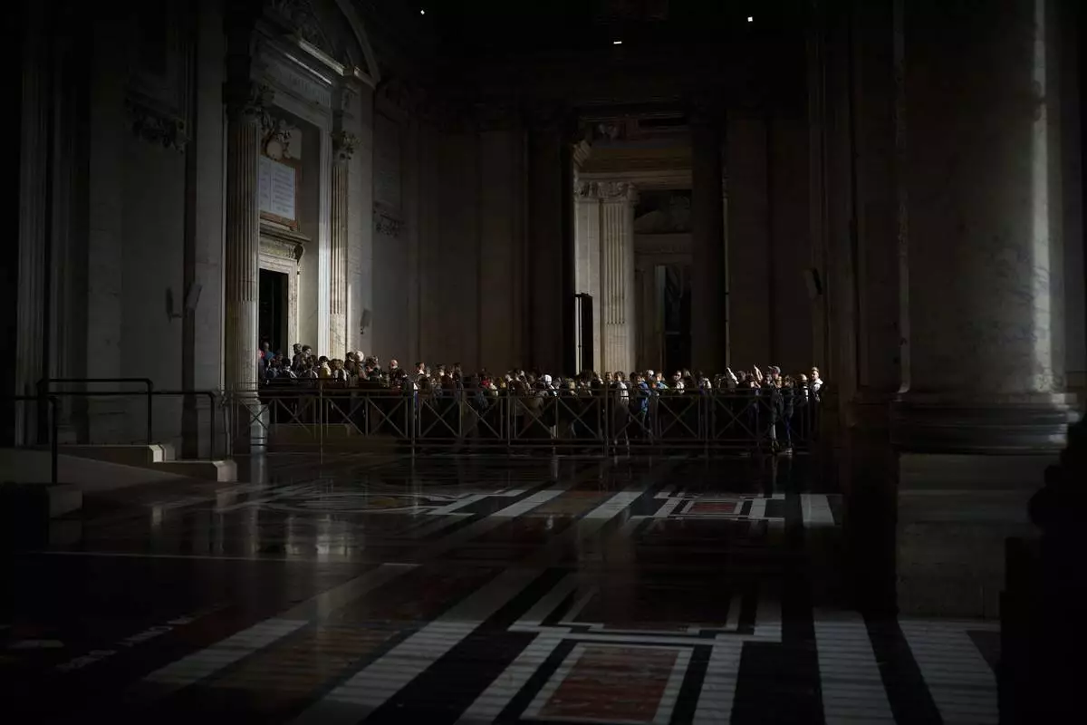 People line up as they enter St. Peter's Basilica to pay their respects to Pope Francis lying in state, at the Vatican, Thursday, April 24, 2025. (AP Photo/Emilio Morenatti)