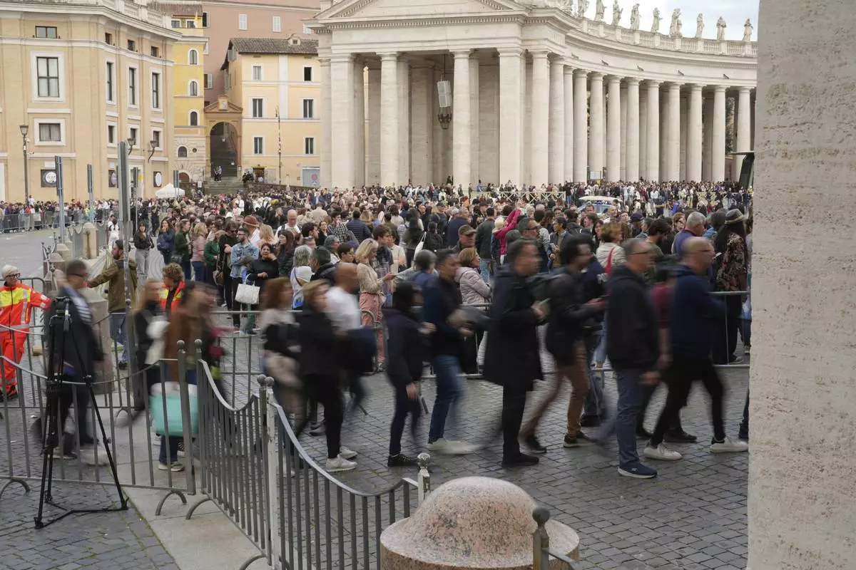 Faithful at St. Peter's Square at the Vatican, Wednesday, April 23, 2025 as the body of the late Pope Francis will lie in state inside St. Peter's Basilica for three days. (AP Photo/Markus Schreiber)