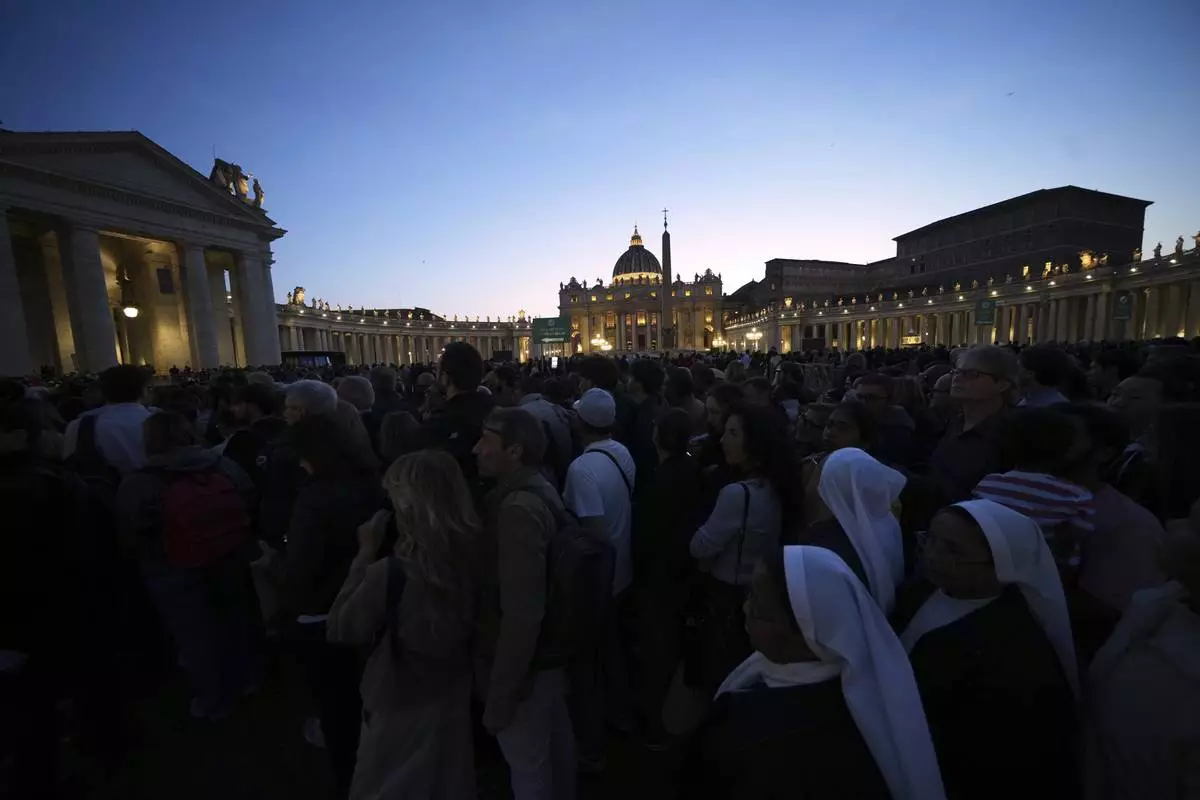 Faithful gather in St. Peter's Square at the Vatican, Wednesday, April 23, 2025 as the body of the late Pope Francis will lie in state inside St. Peter's Basilica for three days. (AP Photo/Alessandra Tarantino)