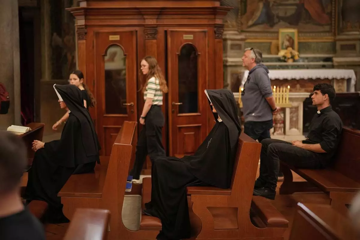 Nuns sit in the Chiesa di Santo Spirito in Sassia, outside Vatican City, Wednesday, April 23, 2025. (AP Photo/Andreea Alexandru)