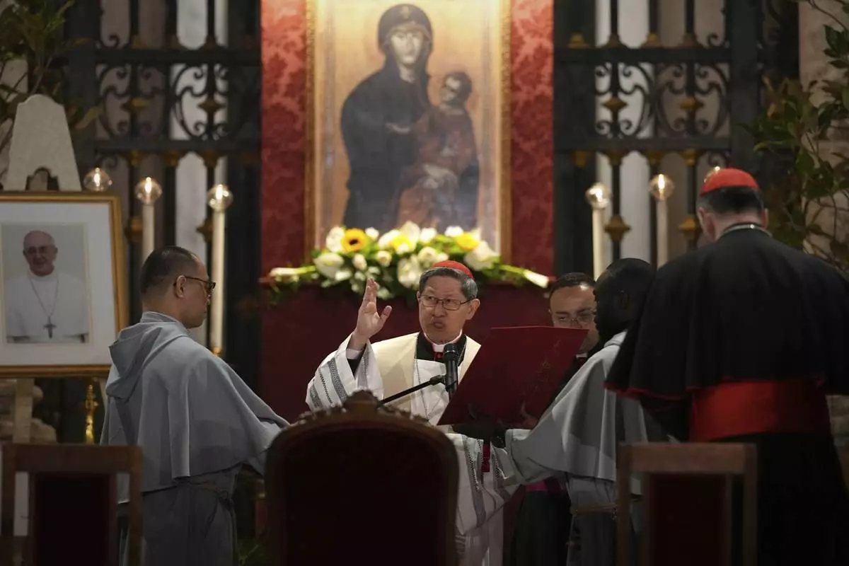 Cardinal Luis Antonio Gokim Tagle leads a rosary prayer outside the Santa Maria Maggiore Basilica, where the late Pope Francis will be buried, in Rome, Thursday, April 24, 2025. (AP Photo/Andreea Alexandru)