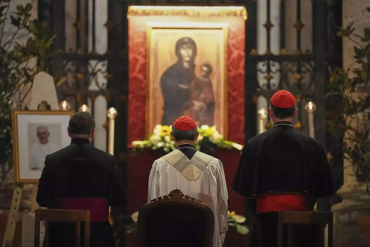 Cardinal Luis Antonio Gokim Tagle, center, leads a rosary prayer outside the Santa Maria Maggiore Basilica, where the late Pope Francis will be buried, in Rome, Thursday, April 24, 2025. (AP Photo/Andreea Alexandru)
