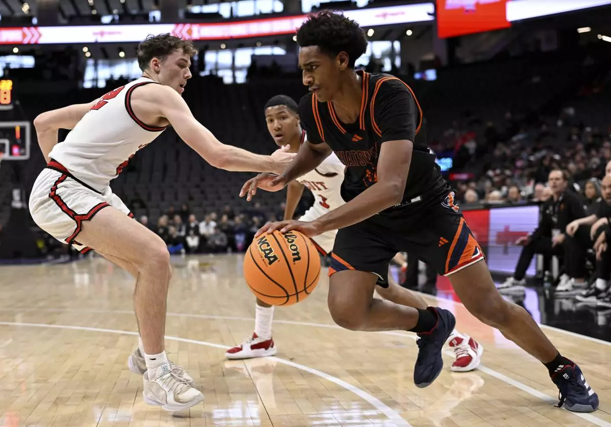 Chatsworth High School basketball player Alijah Arenas, right, is defended by a Jesuit player in the second half of a boys CIF State Division II championship basketball game in Sacramento, Saturday, March 15, 2025. (Keith Birmingham/The Orange County Register via AP)