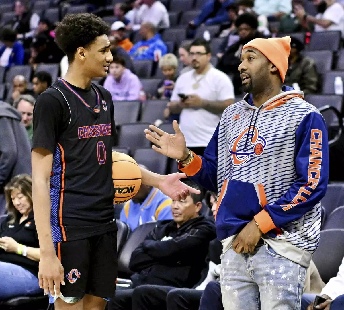 Chatsworth High School basketball player Alijah Arenas, left, talks to his dad, former NBA player Gilbert Arenas before a CIF State Division IV championship basketball game in Sacramento, Saturday, March 9, 2024. (Keith Birmingham/The Orange County Register via AP)