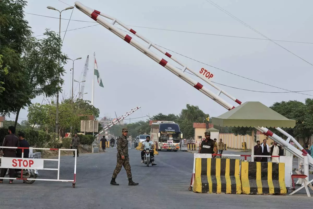 CORRECTS THE NAME OF THE TOWN TO WAGAH, NOT WAHAG - Pakistan's paramilitary soldiers stand guard at a checkpoint near Wagah, a joint border crossing point between the Pakistan and India border, Thursday, April 24, 2025.(AP Photo/K.M. Chaudary)