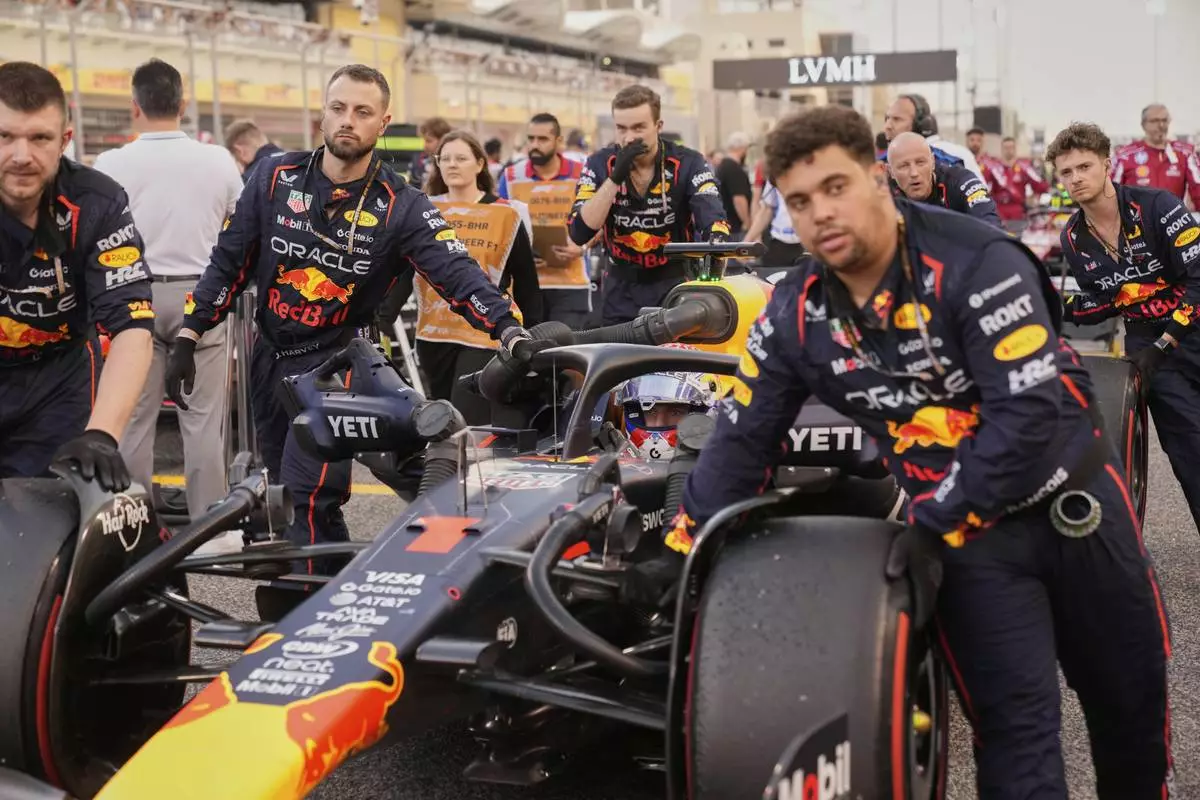 Mechanics push Red Bull driver Max Verstappen of the Netherlands on the starting grid before the the Formula One Bahrain Grand Prix, in Sakhir, Sunday, April 13, 2025. (AP Photo/Darko Bandic)