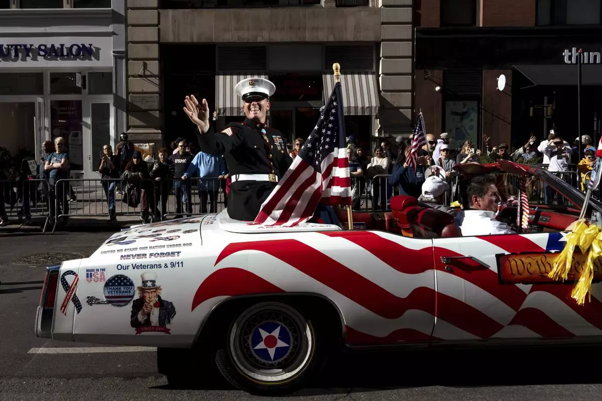 FILE - Grand Marshal Dakota Meyer, U.S. Marine Corps, a Medal of Honor recipient, waves from a car during the annual Veterans Day Parade, Nov. 11, 2024, in New York. (AP Photo/Adam Gray, File)