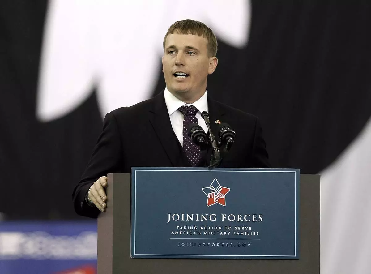 FILE - Dakota Meyer, a Marine veteran of the war in Afghanistan and a Medal of Honor recipient, speaks to soldiers and spouses at a jobs fair in Fort Campbell, Ky., April 23, 2014. (AP Photo/Mark Humphrey, File)