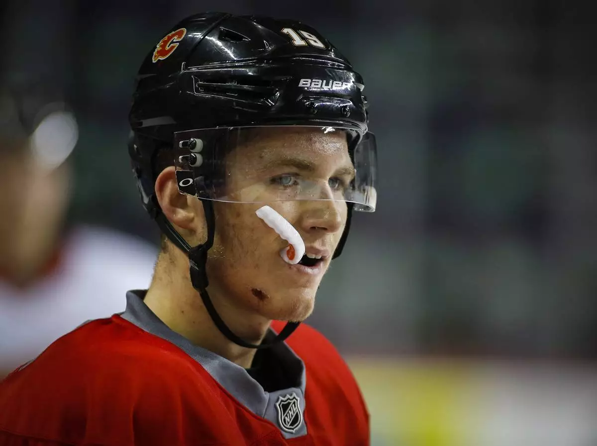 FILE - Calgary Flames' Matthew Tkachuk, watches drills during NHL hockey training camp in Calgary, Alberta, Friday, Sept. 23, 2016. (Jeff McIntosh/The Canadian Press via AP, File)
