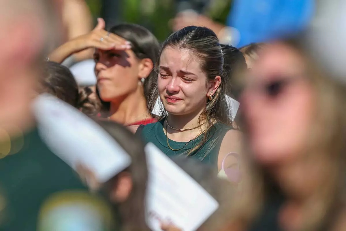 A student mourns during a vigil on the Florida State campus at Langford Green, Tallahassee, Fla., Friday, April 18, 2025, after a school shooting the day before. (AP Photo/Gary McCullough)