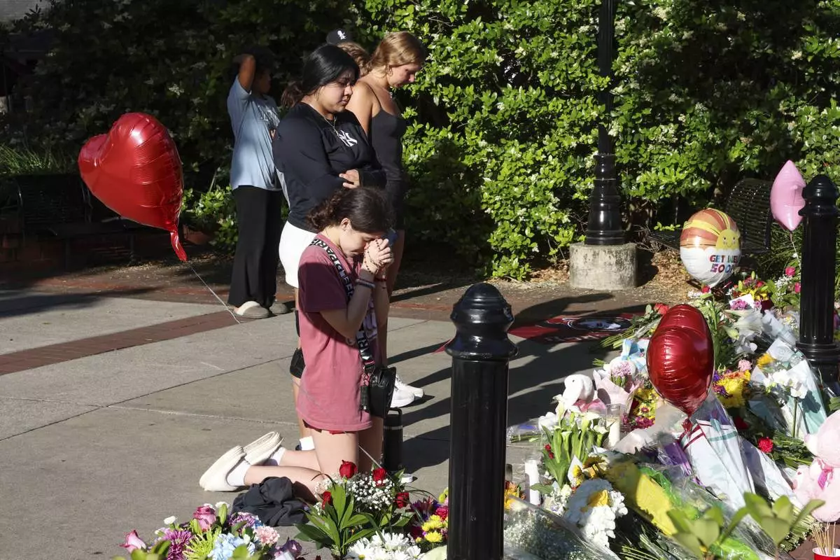 Students gather on a stretch of sidewalk near the center of the Florida State campus in sight of the Student Union building, Tallahassee, Fla., Friday, April 18, 2025. (AP Photo/Gary McCullough)