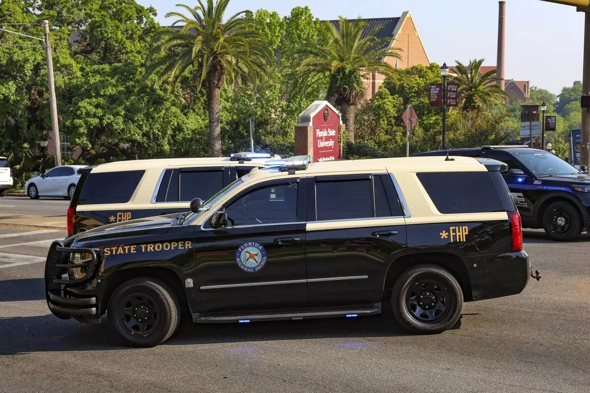 The Florida State Student Union building is seen behind law enforcement vehicles in Tallahassee, Fla., Thursday, April 17, 2025. (AP Photo/Gary McCullough)