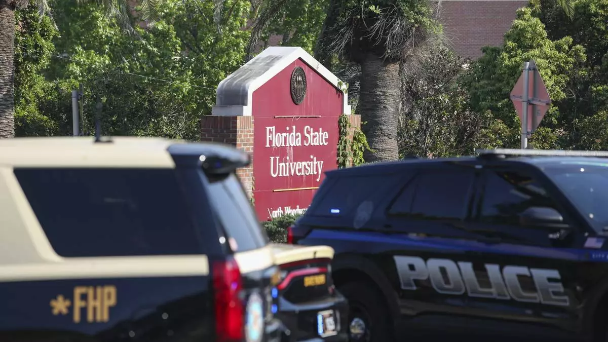 The Florida State Student Union building is seen behind law enforcement vehicles in Tallahassee, Fla., Thursday, April 17, 2025. (AP Photo/Gary McCullough)