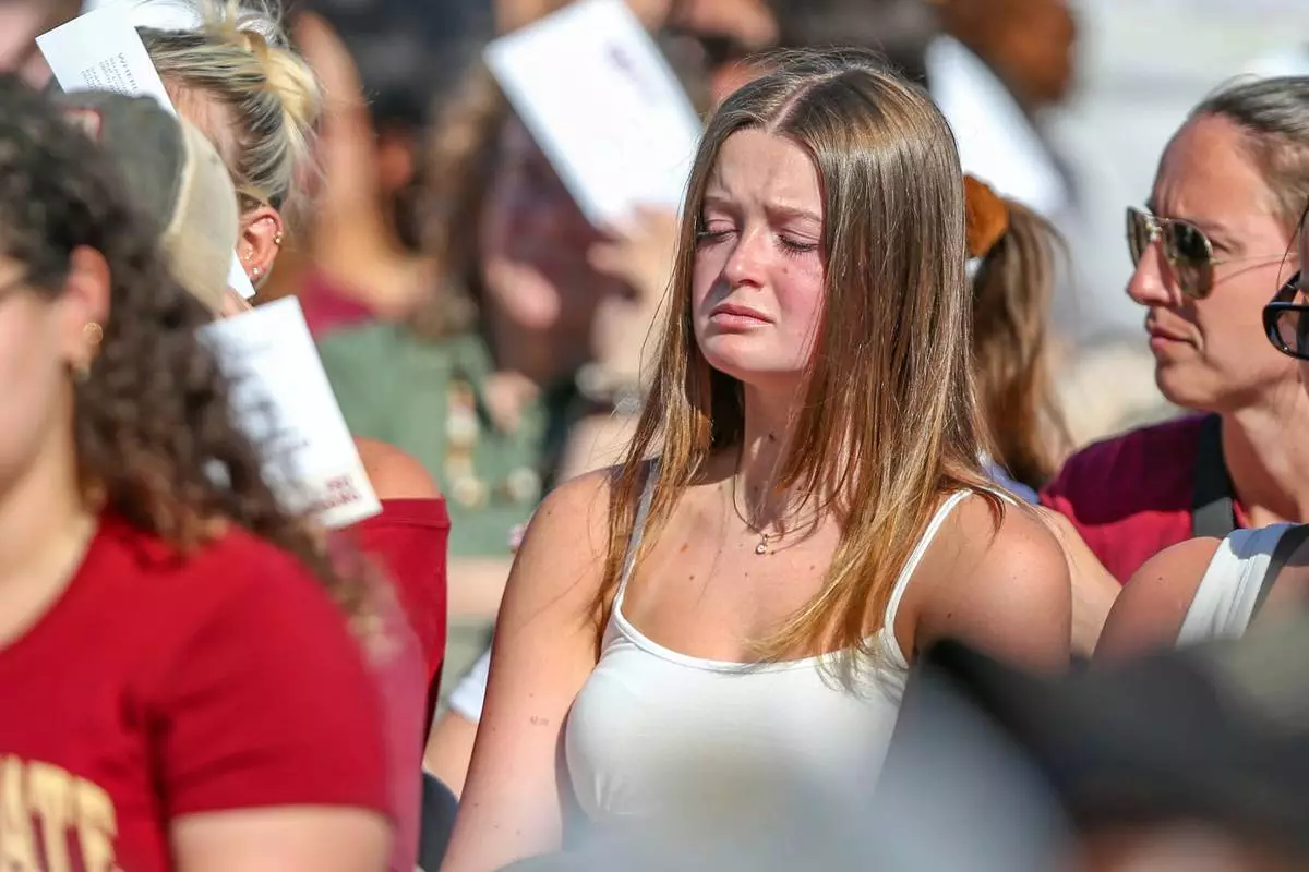 A student mourns during a vigil on the Florida State campus at Langford Green, Tallahassee, Fla., Friday, April 18, 2025. (AP Photo/Gary McCullough)
