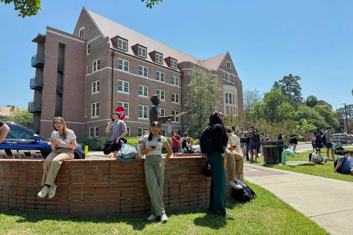Florida State University students wait for news amid an active shooter incident at the school’s campus in Tallahassee, Fla., Thursday, April 17, 2025 (AP Photo/Kate Payne)